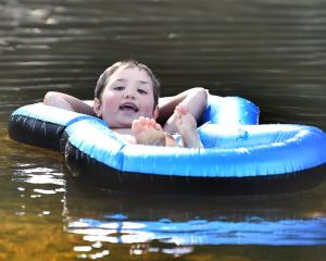 Remi Nicholson (5), of Dunedin, cools down at Outram Glen yesterday. PHOTO: CHRISTINE O'CONNOR