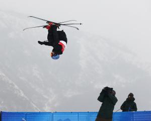New Zealand’s Nico Porteous gets inverted during his second run in the men’s freeski halfpipe...