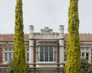 A couple of impressive Italian cypresses stand guard near a main entrance at Otago Girls’ High...