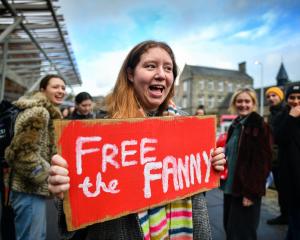 An activist joins a rally outside the Scottish Parliament in support of the Scottish Government’s...