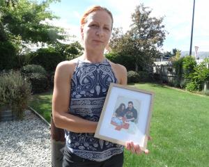 Anna Gorobets holds a photo of her sister’s family who are trapped in Ukraine. PHOTO: LUCY WORMALD