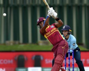 West Indies Batsman Hayley Matthews hits the ball while watched by England wicketkeeper Amy Jones...