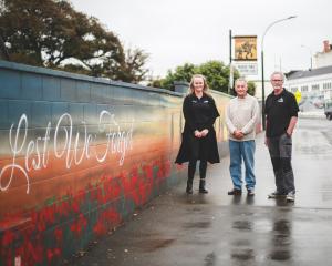 Admiring the mural on a wall outside the Waimate Town &amp; Country Club are (from left) club...