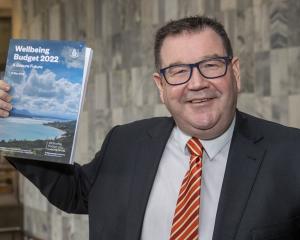 Finance Minister Grant Robertson with a copy of his Wellbeing Budget 2022 at Parliament,...
