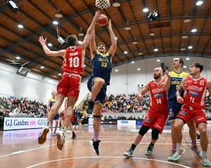 Sam Timmins drives to the hoop while guarded by Canterbury Rams defender Hunter Adam during the...