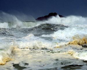 Big waves whip up the ocean off St Clair, with White Island in the background. Photo by Gerard O...