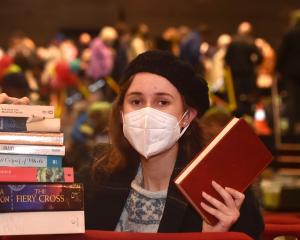 Student Renee Shields holds a stack of books she bought at the Regent Theatre $1 Book Sale...