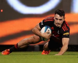 Will Jordan crosses to score for the Crusaders against the Brumbies. Photo: Getty Images
