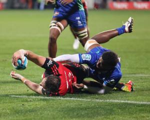 Crusader Sam Whitelock reaches for a try in front of a home crowd last night. Photo: Getty Images 