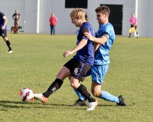 Dunedin City Royals player Ollie Petersen (right) tussles with Luke McKay (Selwyn) during the...