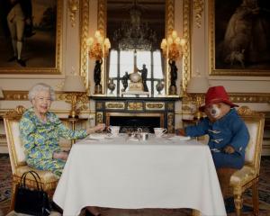Queen Elizabeth and Paddington Bear have tea together at Buckingham Palace. Photo: Buckingham...