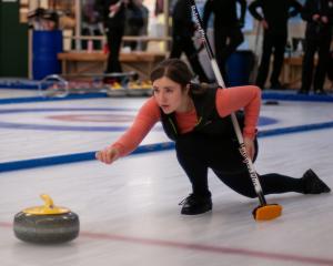 Ariel Webber, of Auckland, releases her stone during a match at the New Zealand Curling...