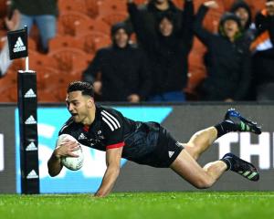 Maori All Blacks wing Shaun Stevenson dives over to score against Ireland in their match in...