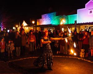 Queenstown performer Milly B dances with fire in Arrowtown’s Buckingham St during the inaugural...