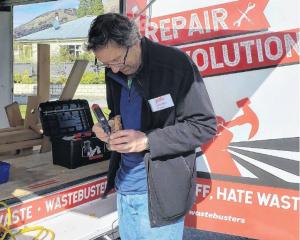 A volunteer fixer keeps another precious belonging in circulation at a repair event. PHOTO: ABBEY...