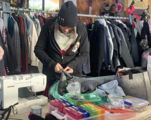 Queenstown’s Kate Robinson from Stitch N Time clothing repairs fixes another zip to get a down...