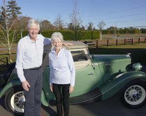 Councillor Stuart Wilson and wife Betty with his first car, a Morris Eight Sport. Photo: Supplied