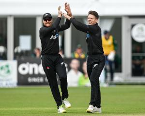 Michael Bracewell celebrates a wicket with Martin Guptill during the second ODI against Ireland....
