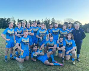 Otago University rugby league players and former representative Alex Familton celebrate getting...