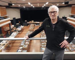 Wanaka Rotary Club member Mike Elliott stands in front of the 5000-7000 books on sale this...