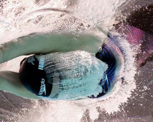 Erika Fairweather dives into the pool to begin her 400m freestyle final at the Commonwealth Games...