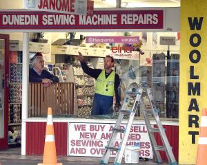 Dunedin Sewing Machine Repairs owner Mike McNulty watches as a glazier assesses ...