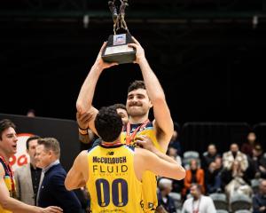 Nuggets captain Sam Timmins holds the trophy as he and teammates celebrate the win. Photo:...