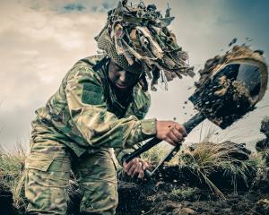 Otago Spirit player and NZ Army Reserve Force soldier Leah Miles digs in during a training...