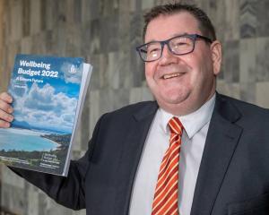 Finance Minister Grant Robertson with a copy of his Wellbeing Budget 2022 at Parliament. Photo:...