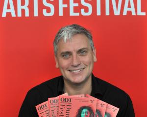 Dunedin Arts Festival director Charlie Unwin with the 2022 festival programme. PHOTO: SUPPLIED