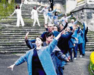 Dunedin residents take part in Us, a choreographed processional mass movement event, as part of...