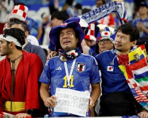 Supporters of Japan show their dismay after being knocked out of the cup, beaten by Croatia in a...