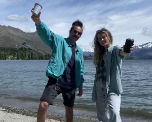 Hemi Cordell and Catrin Smith take their coffee and reusable cups down to the lake in Wanaka....