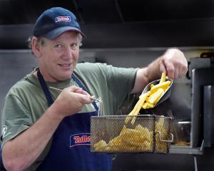 Preparing for the dinner rush, Aaron Hook, owner of the recently opened Hooked fish and chip shop...