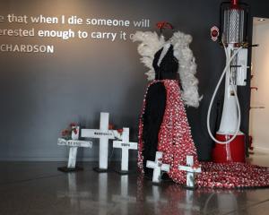 Designer Charlotte Graff hand-stitched 2779 poppies on to the train of the Anzac Angel garment,...
