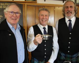Balfour RSA president Murray McKeown (left) celebrates with Hokonui Celtic Pipe Band member Paul...