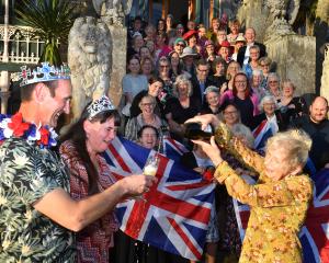 Larnach Castle owner Margaret Barker pours some bubbles for Liam and Jacqueline Sparrow during a...