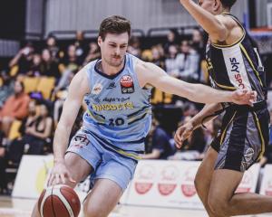 Michael Harris drives towards the hoop during a National Basketball League match against the...