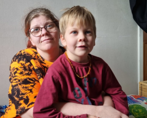 Bronwyn McCown and five-year-old Caleb. She has moved her three children into the living room....
