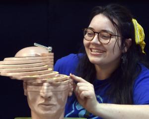 University of Otago PhD student Courteney Westlake examines a section of a brain model during the...