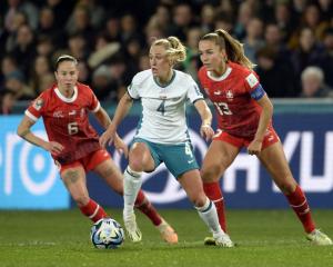 CJ Bott is defended by Swiss players Geraldine Reuteler (left) and Lia Walti. PHOTO: GERARD O’BRIEN