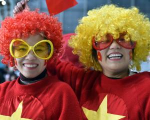 Vietnam supporters Linh Bui (left) and Nguyet Nguyen, both of Auckland, cheer on their team...