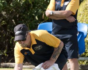 Kerrin Wheeler delivers his bowl as his father Colin watches during the North East Valley...