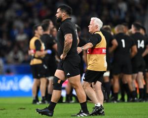 All Blacks prop Tyrel Lomax is helped off the field by physio Pete Gallagher after suffering an...