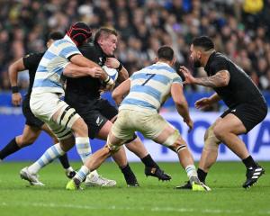 All Black Ethan de Groot (with ball) is tackled by Matias Alemanno of Argentina during the Rugby...