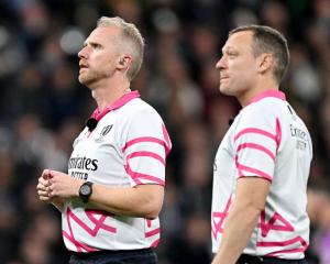 Referee Wayne Barnes and assistant referee Matthew Carley watch the big screen as the TMO reviews...