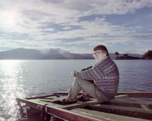 The writer sits at his Broad Bay boat shed in the 1990s. PHOTO: SUPPLIED