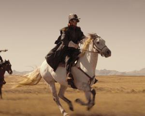 Jed Brophy, cast in part for his skill on a horse, leads a militia posse.