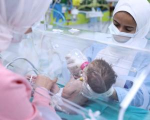 Medics in Egypt's New Administrative Capital near Cairo treat a premature Palestinian baby...