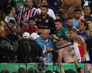Fans clash in the stands with security staff caused a delay to the start of the match. Photo:...